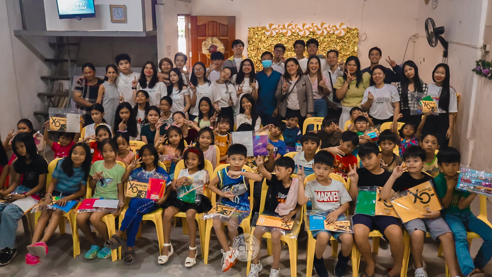 Children receiving school supplies through CLC Foundation