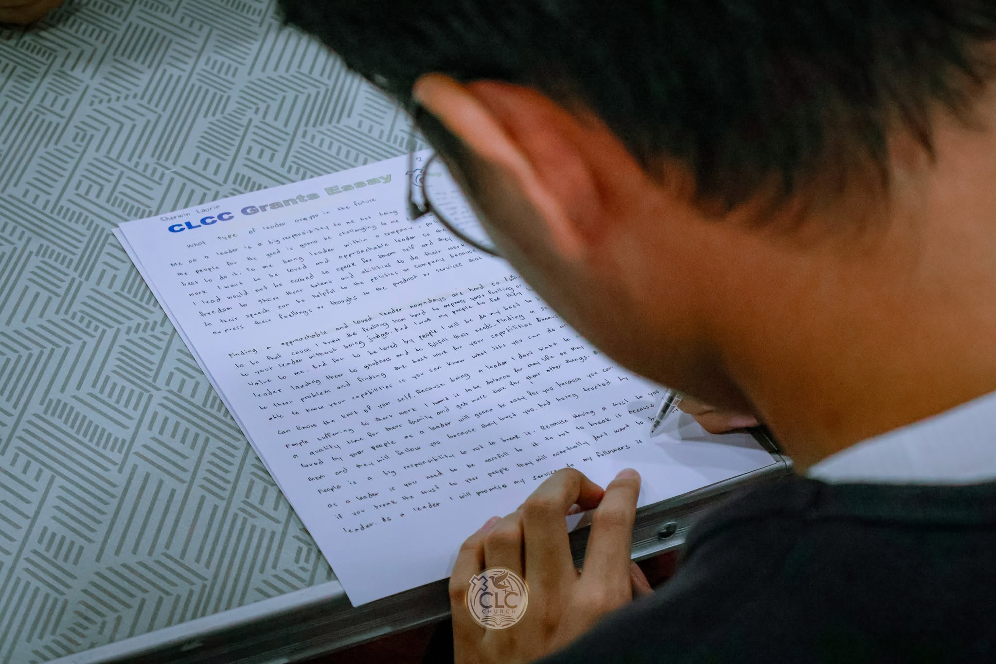 Scholar writing a CLCC grants essay